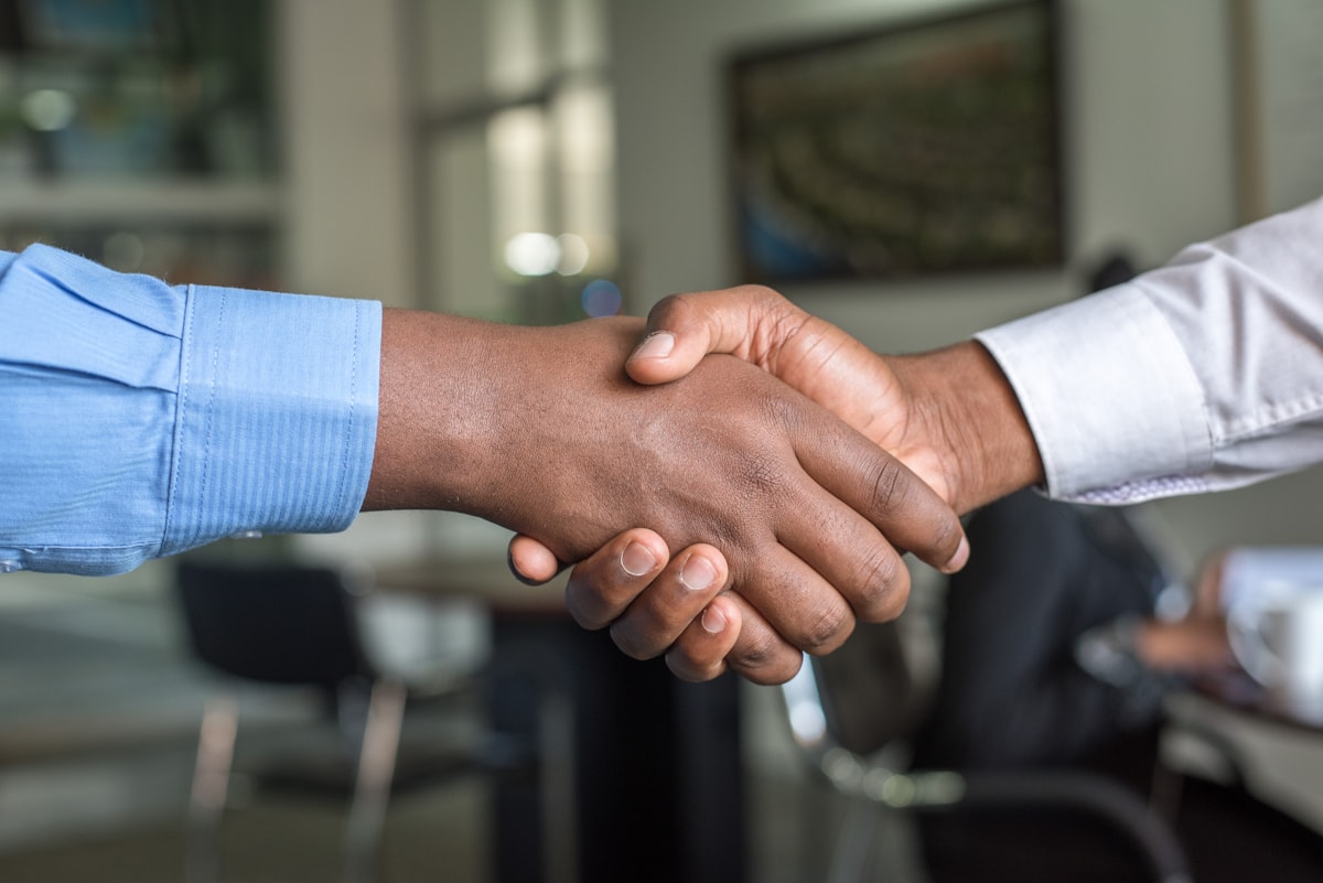 A partnership handshake — refer clients and earn with eSaintLucia