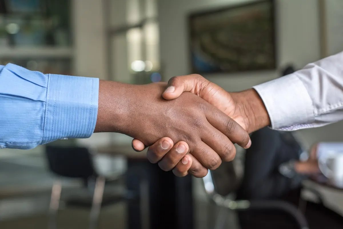 A partnership handshake — deliver integrated solutions with eSaintLucia